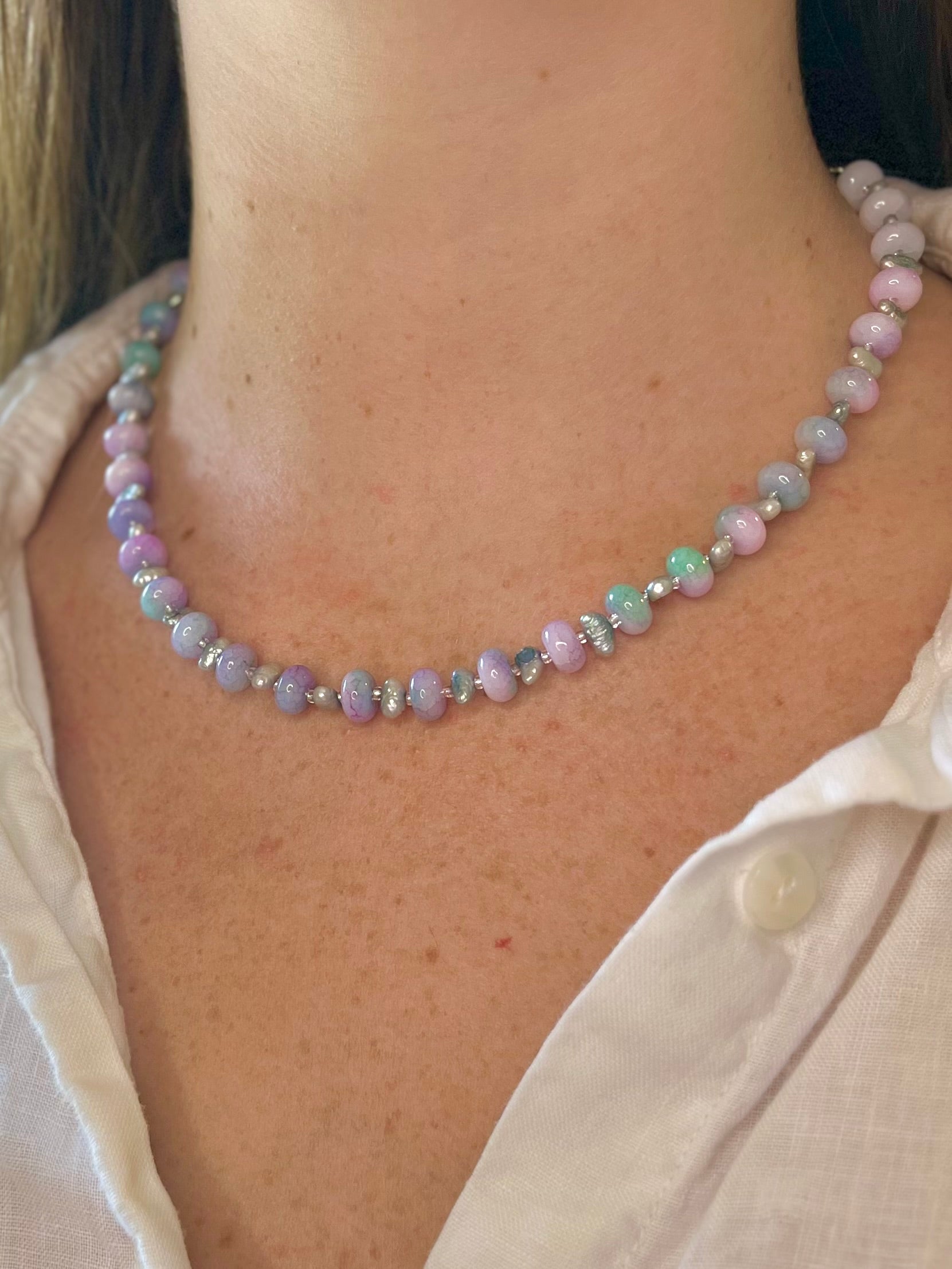 Necklace with multicolored beads worn by a person